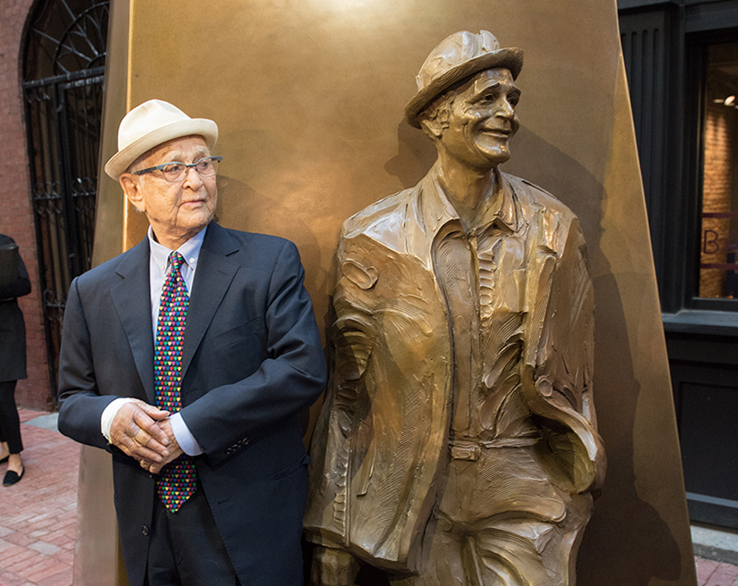 Norman Lear standing next to statue of himself