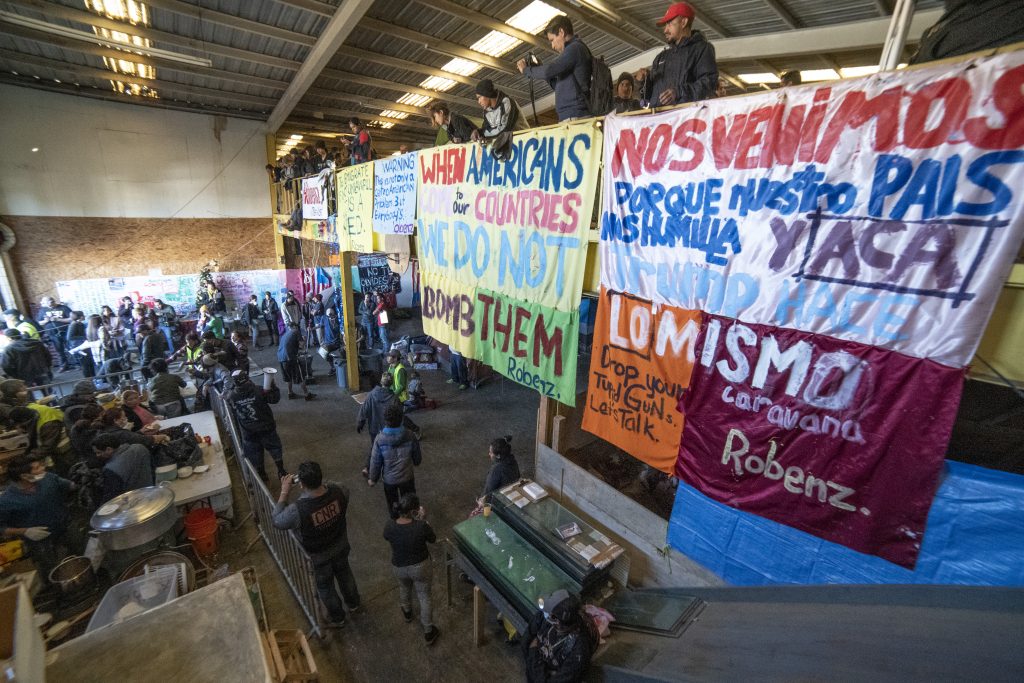 Protestors displayed signs inside a migrant shelter in Tijuana.