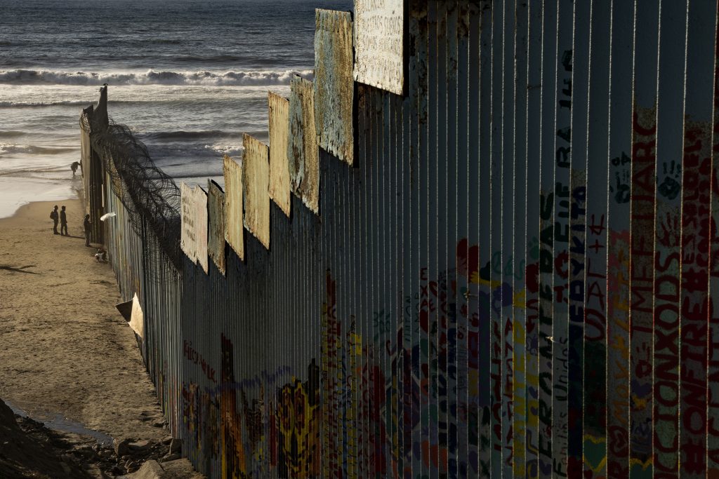 A border wall on the beach separates Mexico from the U.S., but can easily be diverted by walking a few feet into the water and walking around the wall.