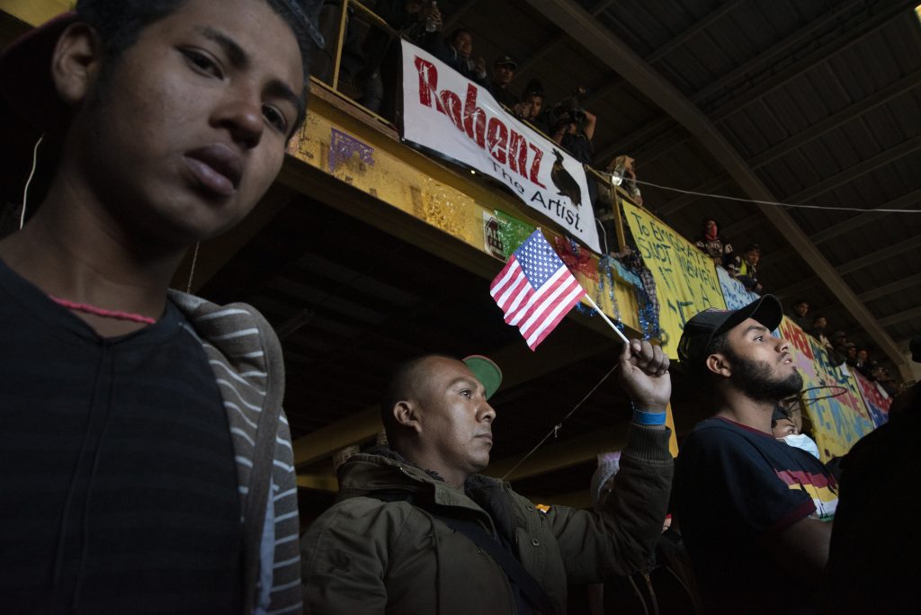 Individuals in a migrant shelter in the north district of Tijuana participate participate in a protest.