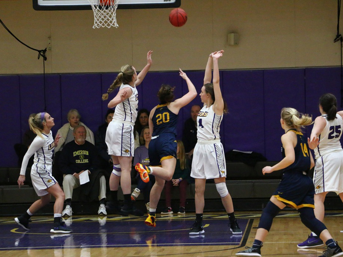 Emerson women basketball players go up for a shot
