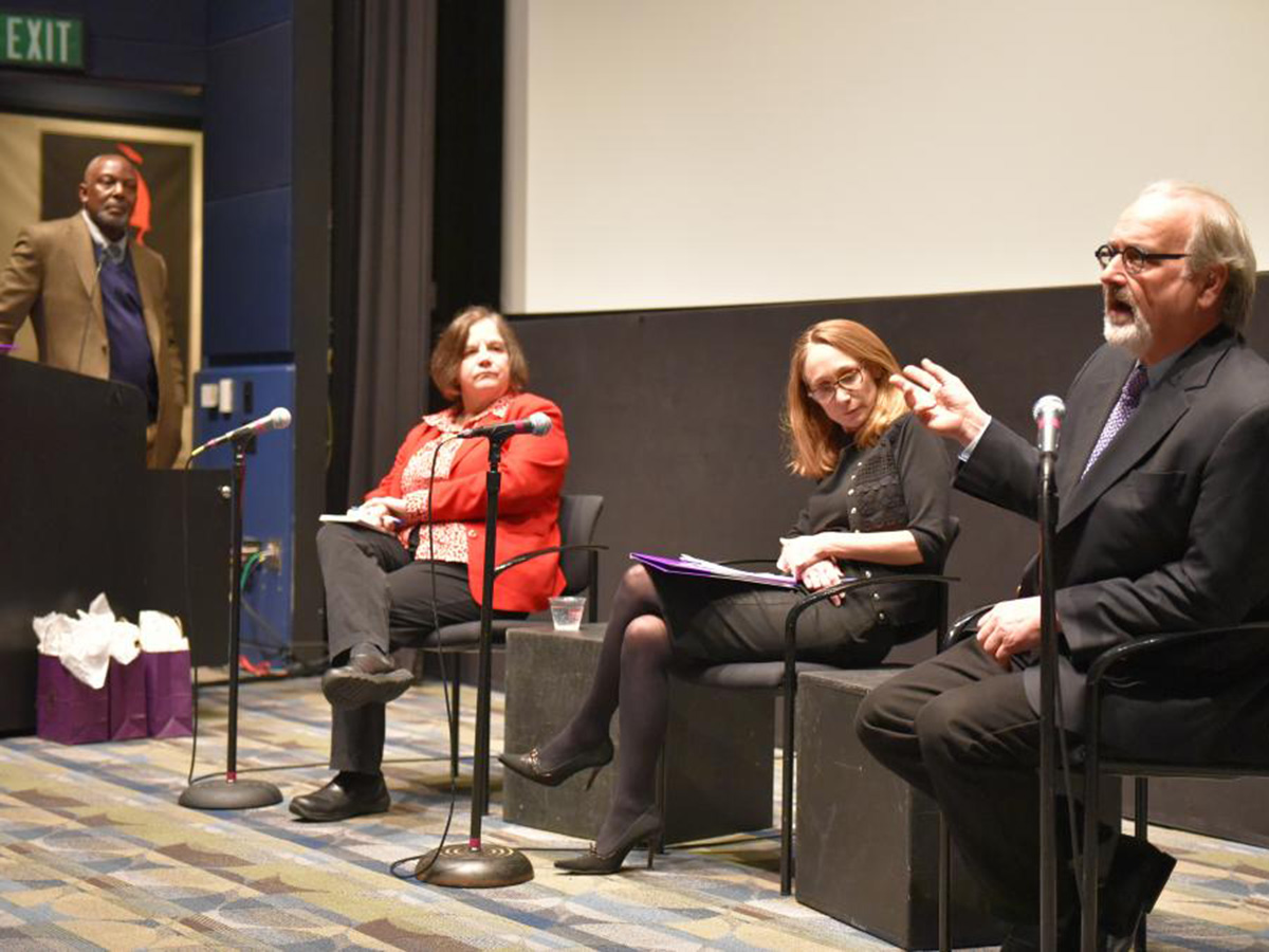 Four panelists in Bright Screening room