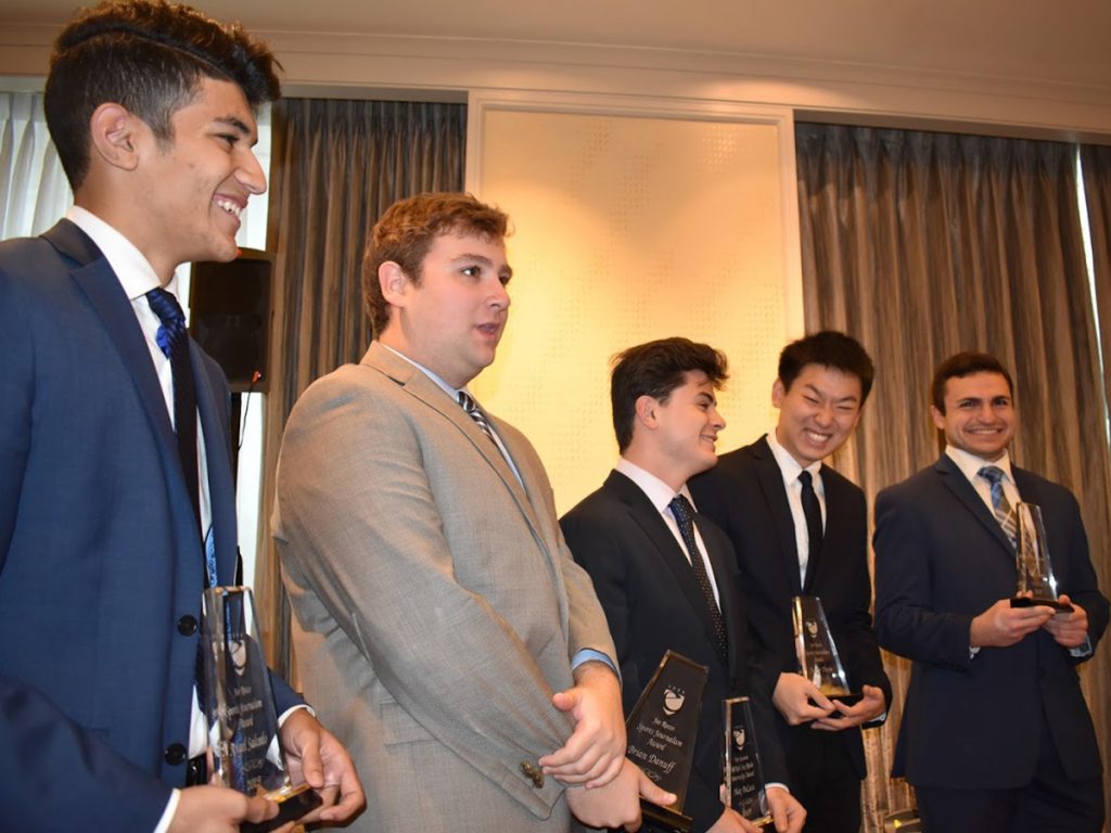 five men holding awards