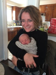 Carrie Cullen holds a baby