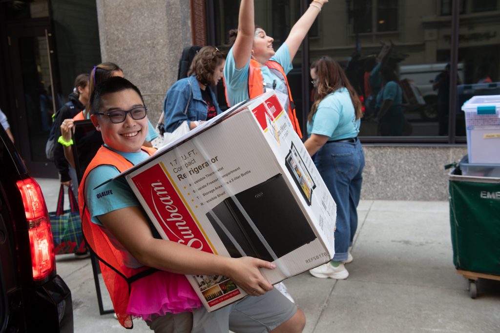 A student carries a box