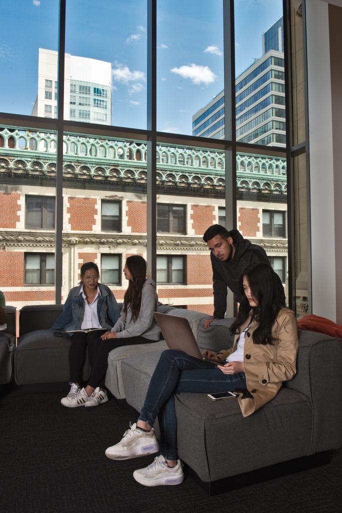 Students work in one of the new community rooms in the Little Building. (Photo by Derek Palmer for Emerson College)