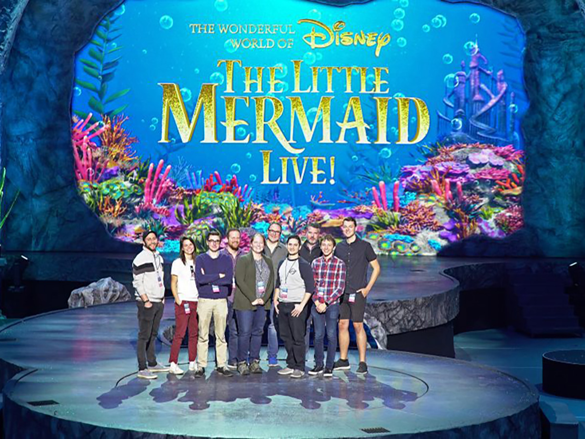 Emerson alums stand on the Little Mermaid set