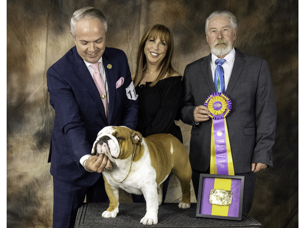 Thor the dog with his handler Eduardo Paris, Kara Gordon, and judge William Gray, after Thor won Best in Specialty Show in Oklahoma City.