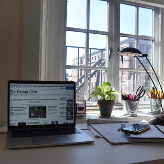 laptop open to Boston Globe