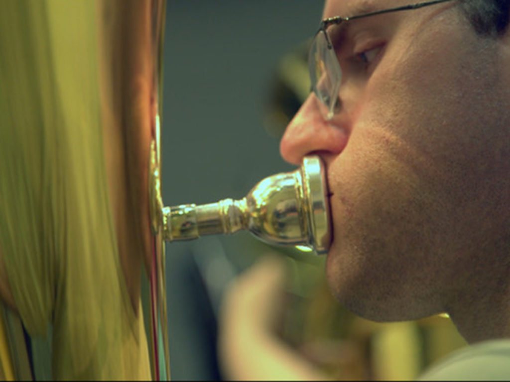 closeup of man playing tuba