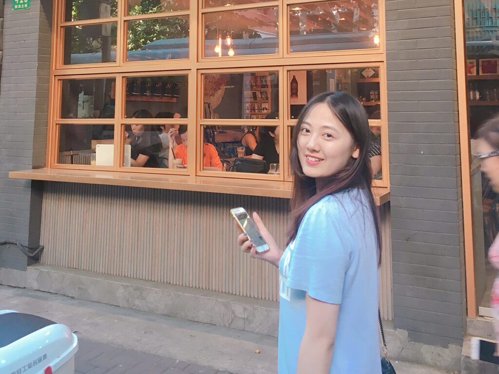 Ye Huang in front of restaurant
