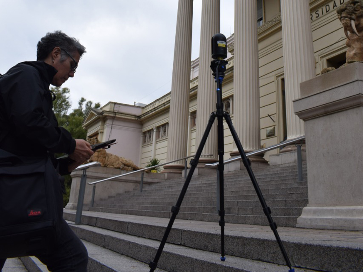 Woman setting up camera on museum steps
