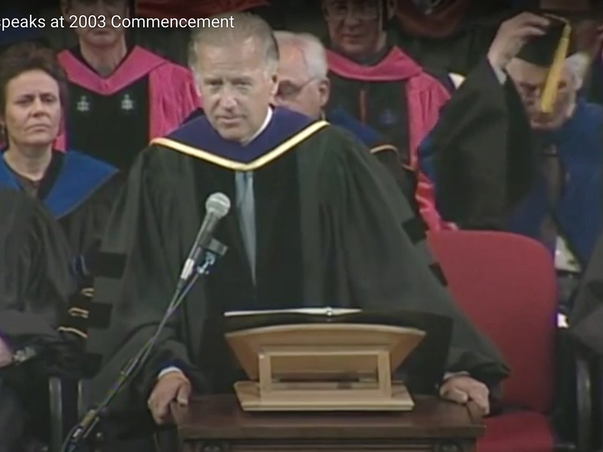 screen shot of joe biden in regalia at podium