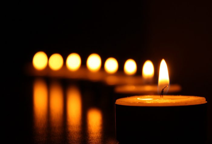 line of lit votive candle