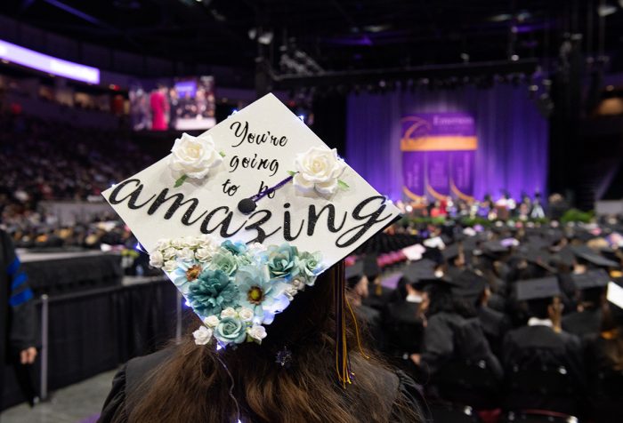 woman with back to camera, mortarboard says "You're gong to be amazing"