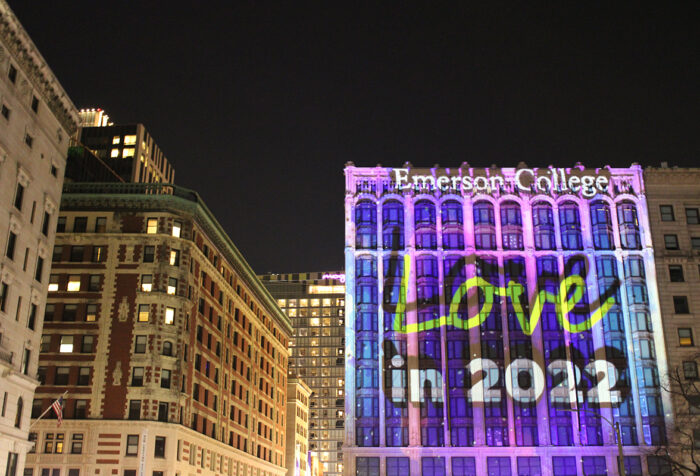 Boston buildings featuring Little building illuminated purple, with the words "Love in 2022" projected onto facade