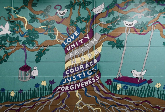 mural of tree reading love, unity, faith, courage, justice, forgiveness
