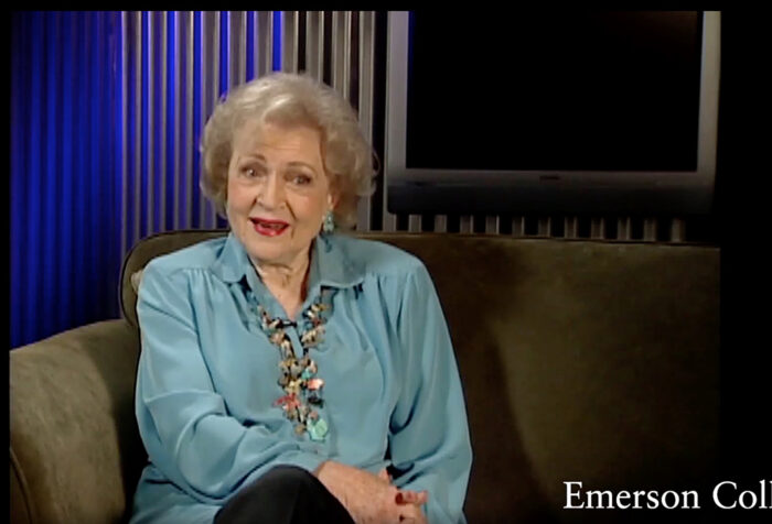 betty white speaks on green couch with screen in background