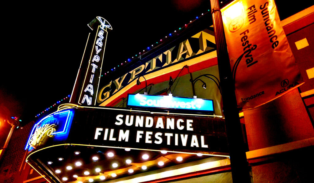 Theater marquis lit up at night and reading Sundance Film Festival