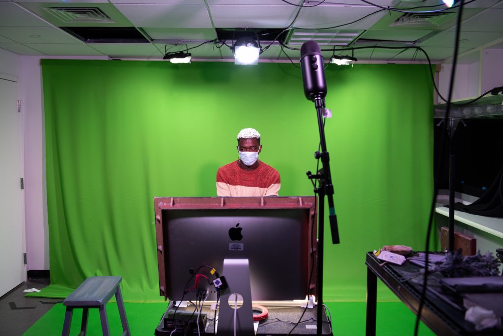 An actor in front of a green screen
