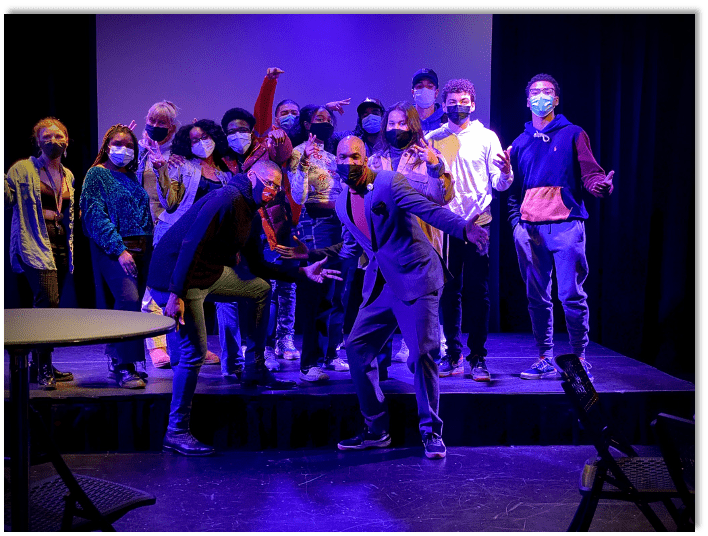 Fourteen people pose together