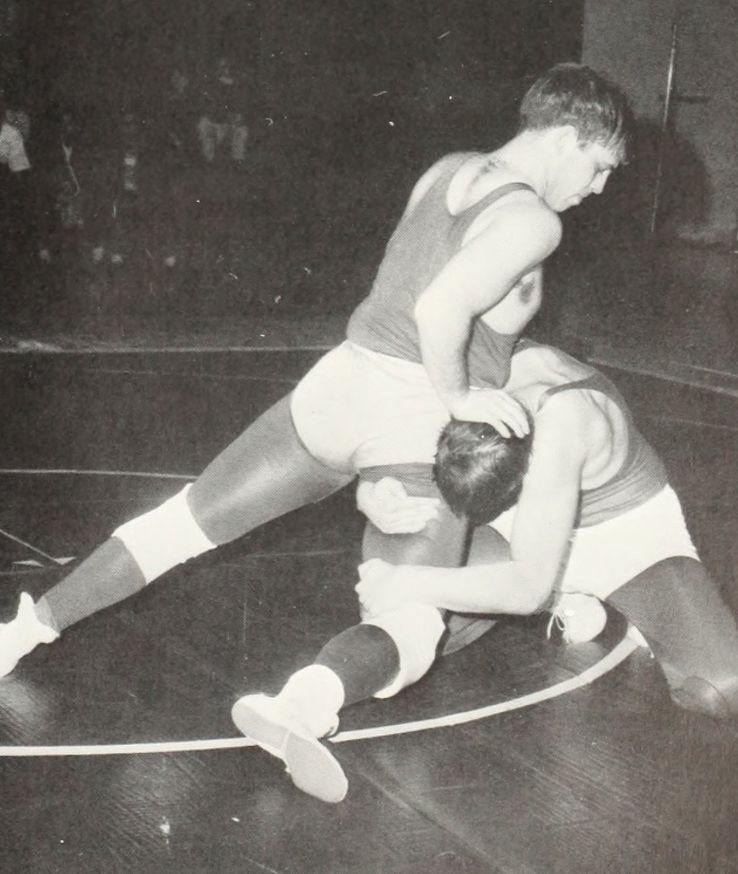 Two men wrestle in a match against each other