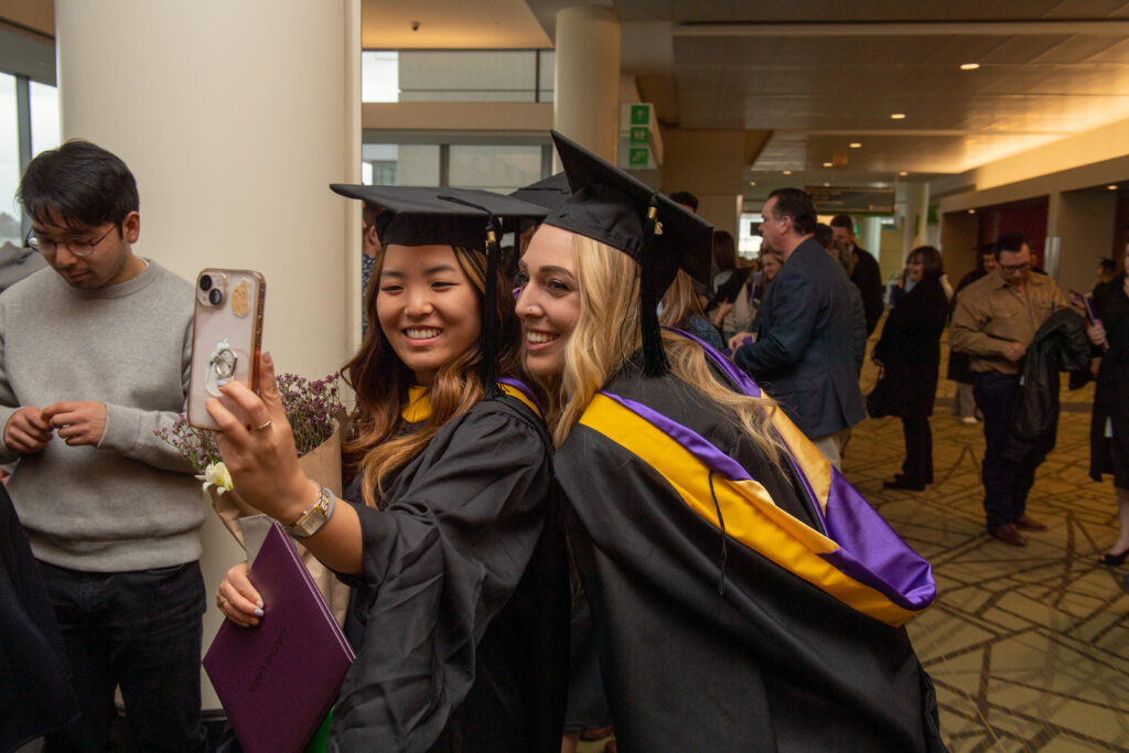 Two graduates take a selfie