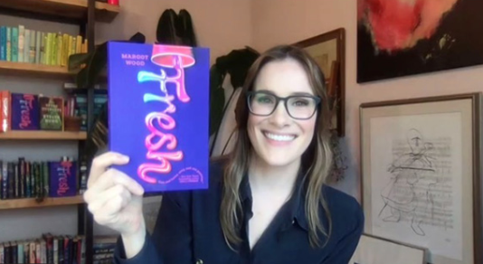 Margot Wood holds a copy of her book Fresh