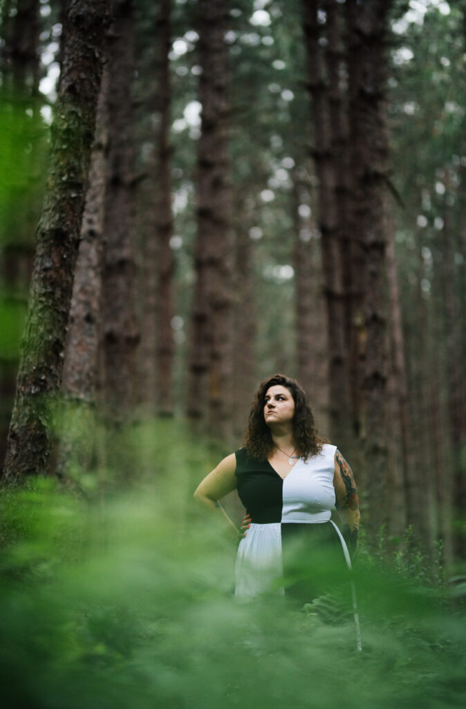 Gina Alibrio stands in the middle of a forest