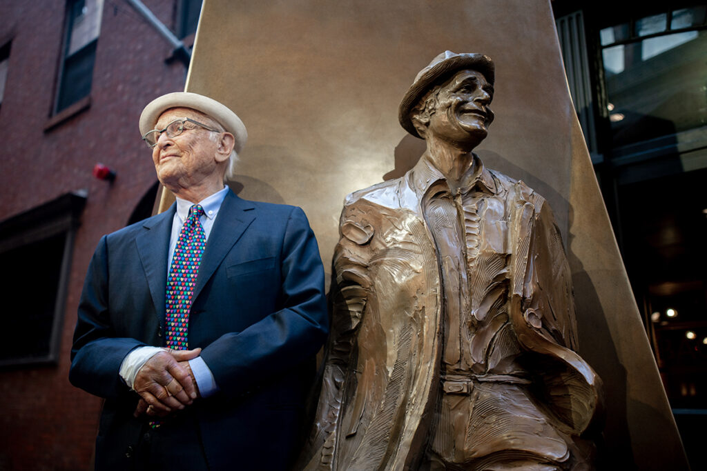 Norman Lear poses with statue of himself