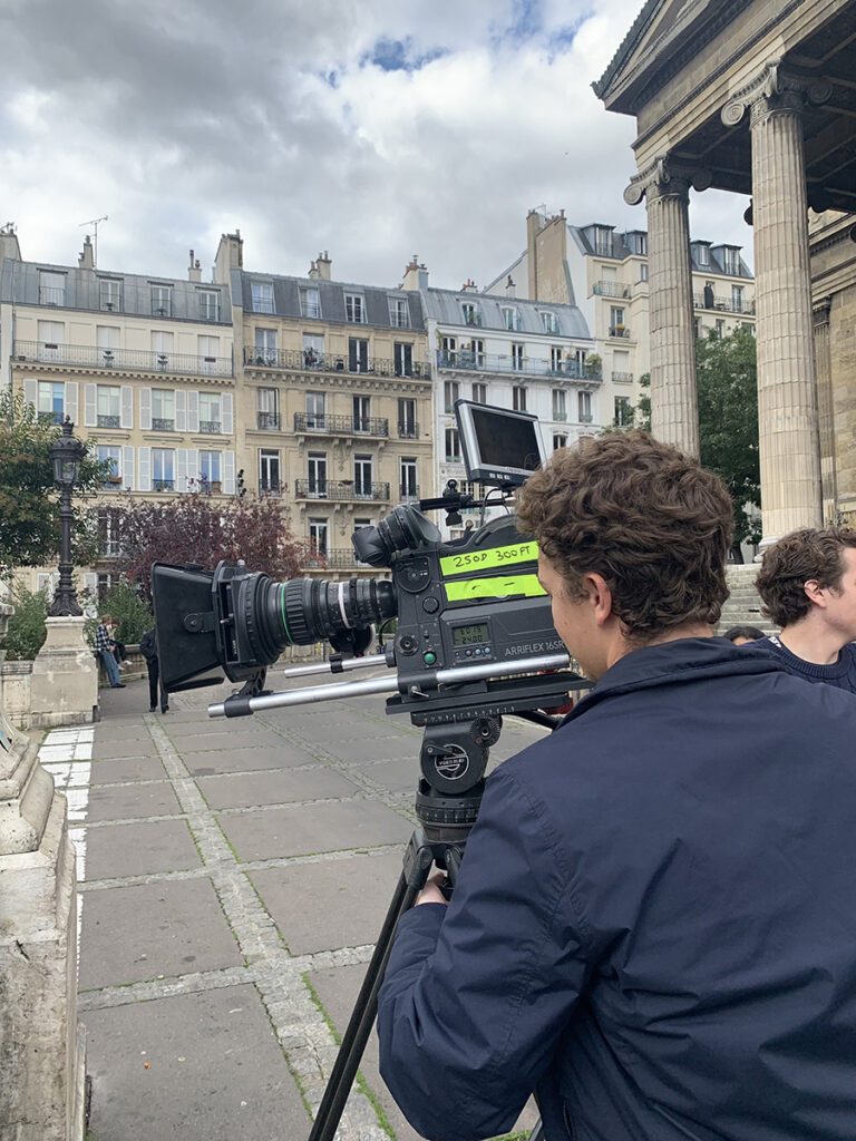 man films on Paris street