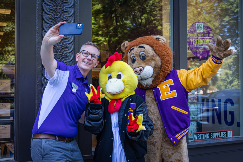 Emerson staff member with chicken and lion mascots