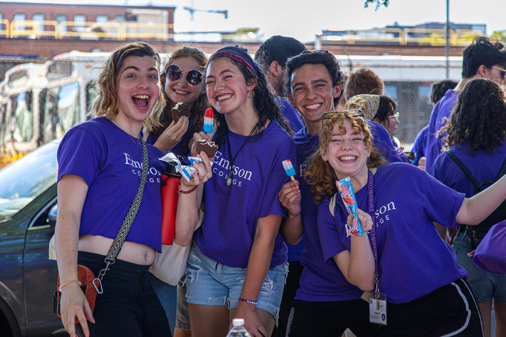 students in purple Ts hold up rocket pops and smile