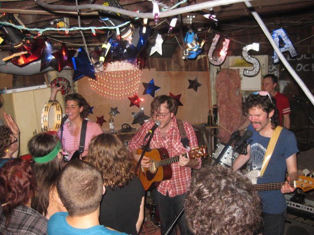 A band performs in a basement