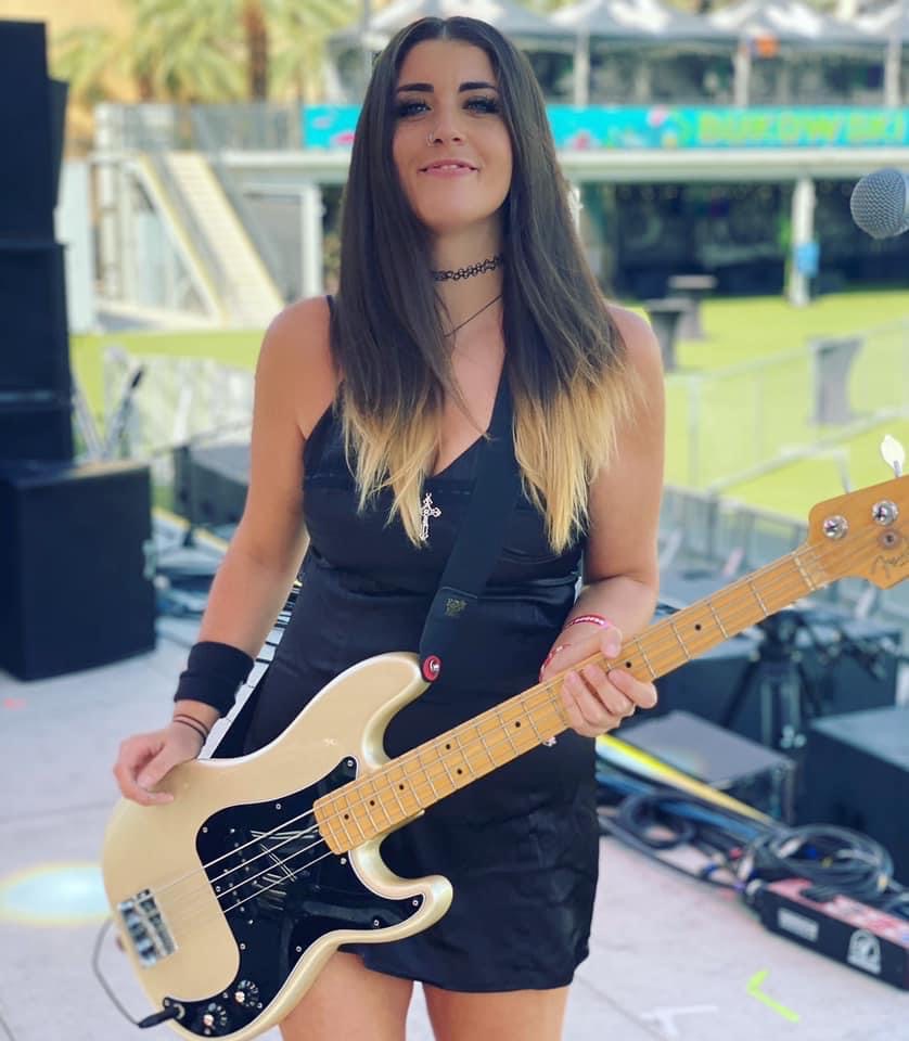 Leanne Bowes poses while holding bass guitar