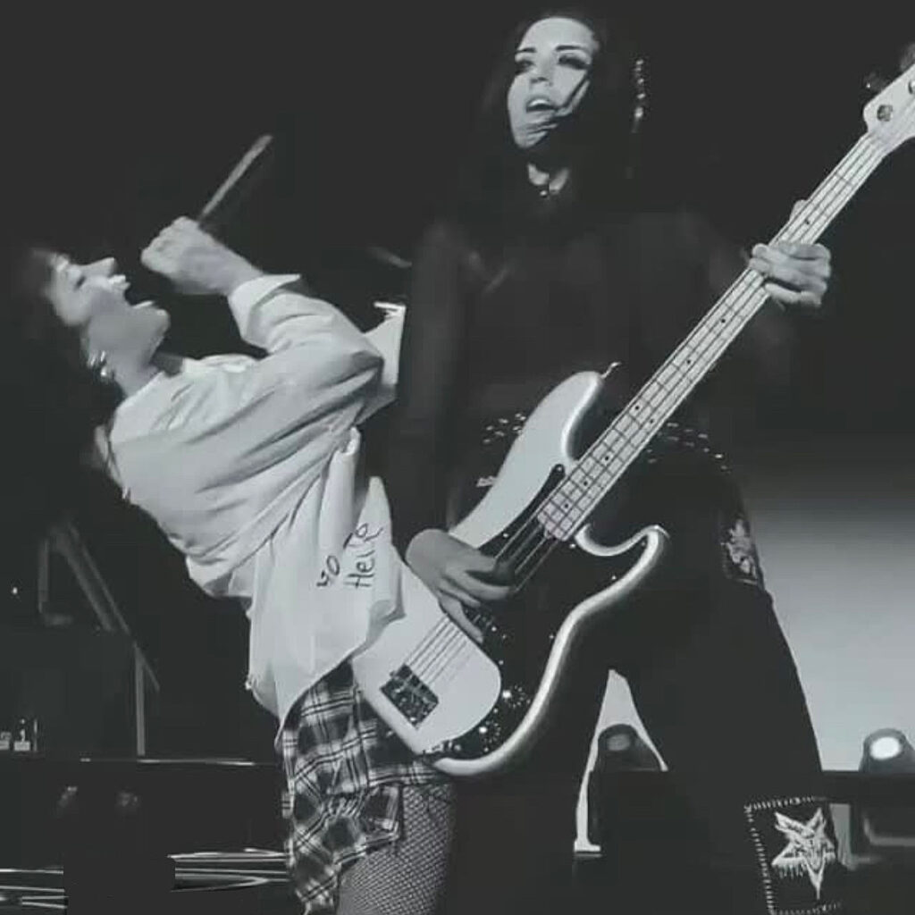Leanne Bowes plays bass guitar while Demi Lovato sings