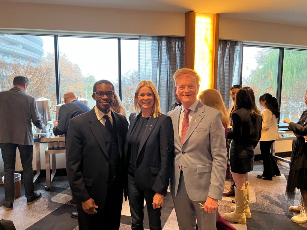 Brent Smith and Dr. Gregory Payne stand with BBC correspondent Katty Kay. 