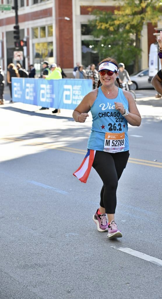 Nydia Bou smiles as she runs a marathon