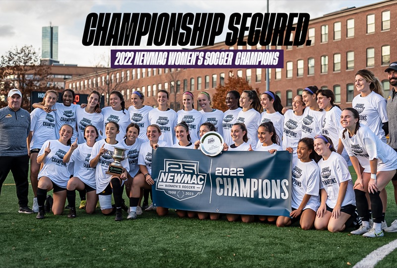 Women's soccer team poses for a photo after winning NEWMAC championship