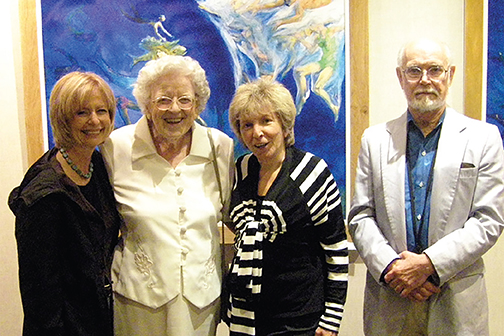 Barbara Rutberg, Charlotte Lindgren, Jackie Liebergott, and Tom Dahill stand in front of one of Tom's paintings