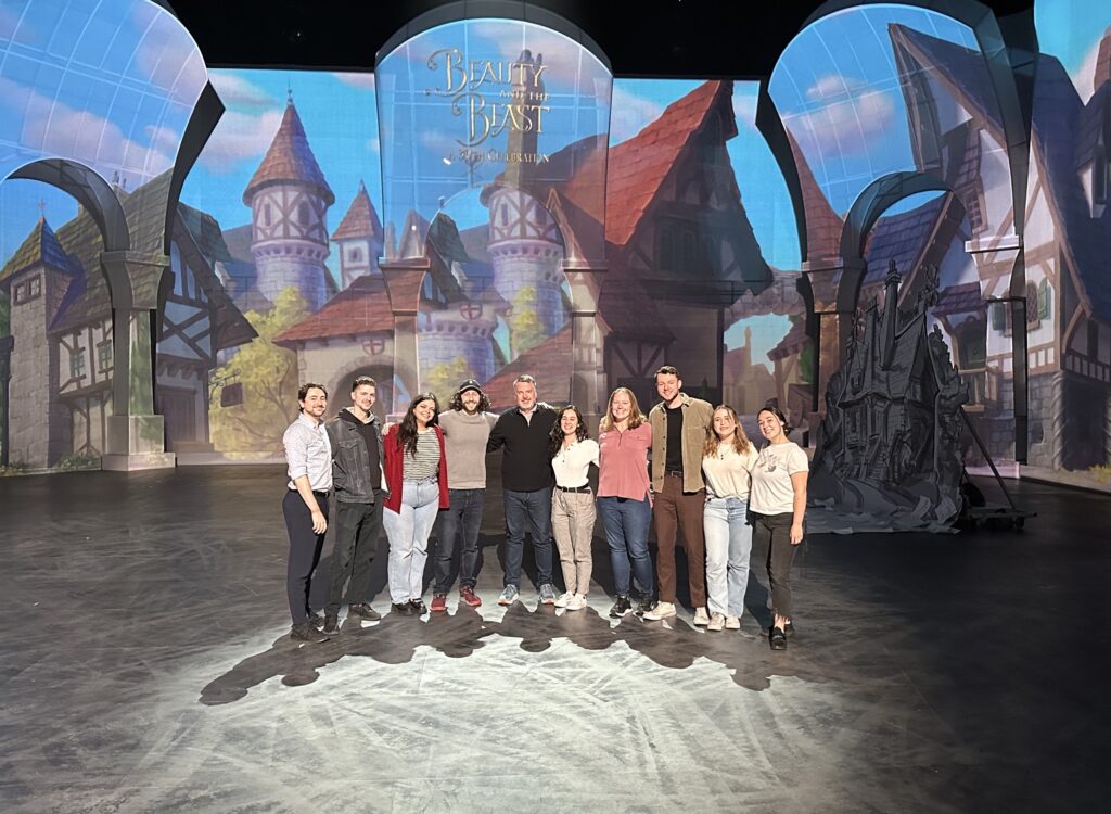 10 Emersonians stand on the set of The Beauty and the Beast