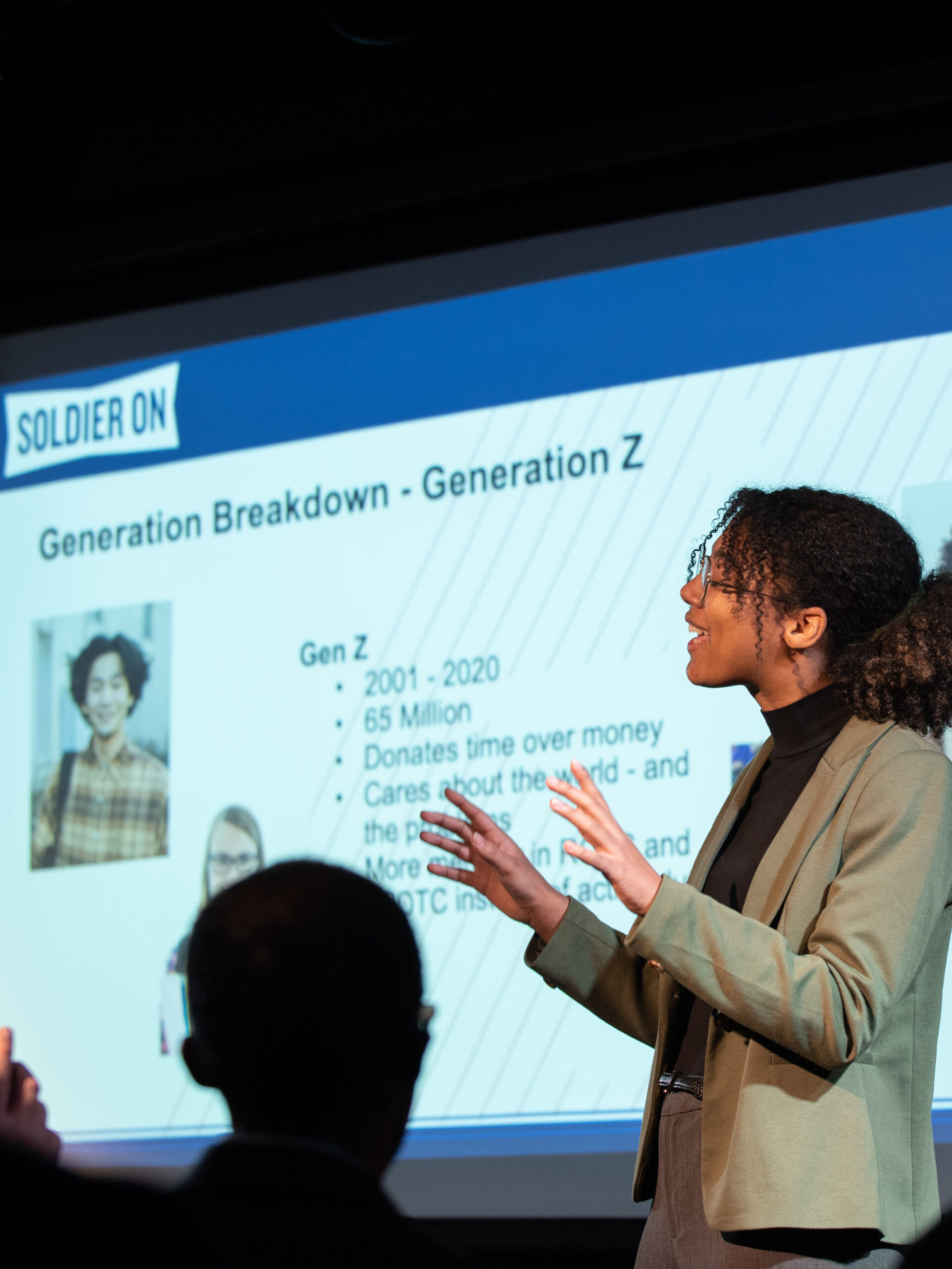 Woman speaks in front of screen that reads "Generation Breakdown- Generation Z"