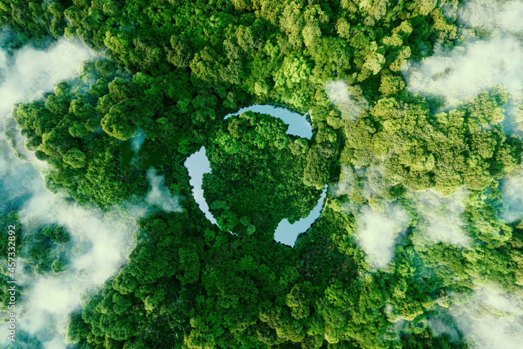 aerial photo of forest with lakes forming the shape of three arrows pointing in a circle