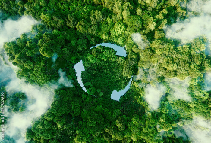 aerial photo of forest with lakes forming the shape of three arrows pointing in a circle