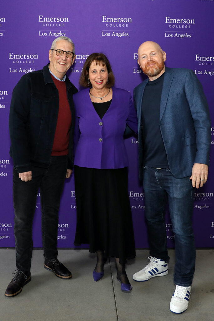 Doug Herzog, Martie Cook and Bill Burr pose in front of a purple Emerson branded backdrop