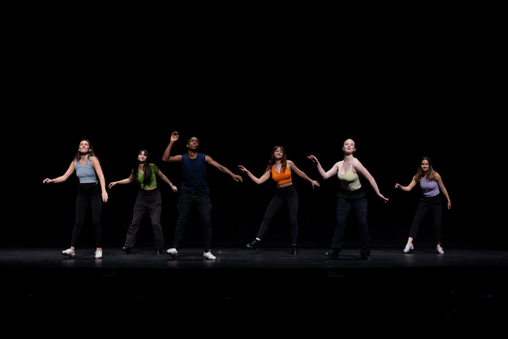 A group of people dance on stage