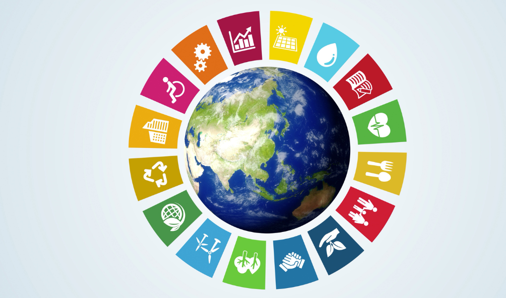 Graphic representing the United Nations' 17 Sustainability Goals. Individual, colored quadrilaterals surround a cut-out of the Earth.