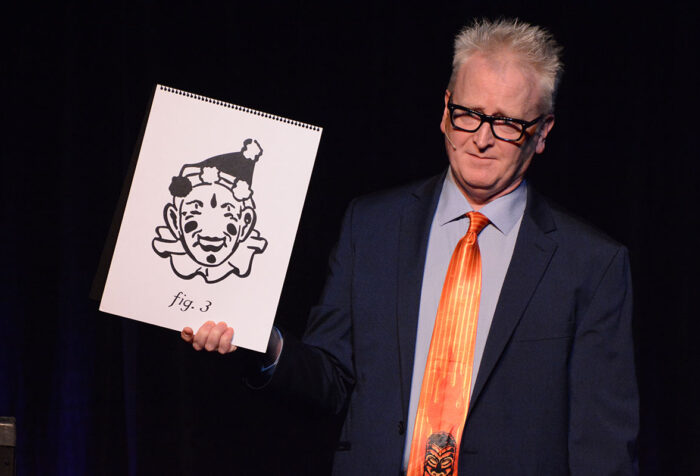 Michael Bent holds up a drawing a clown