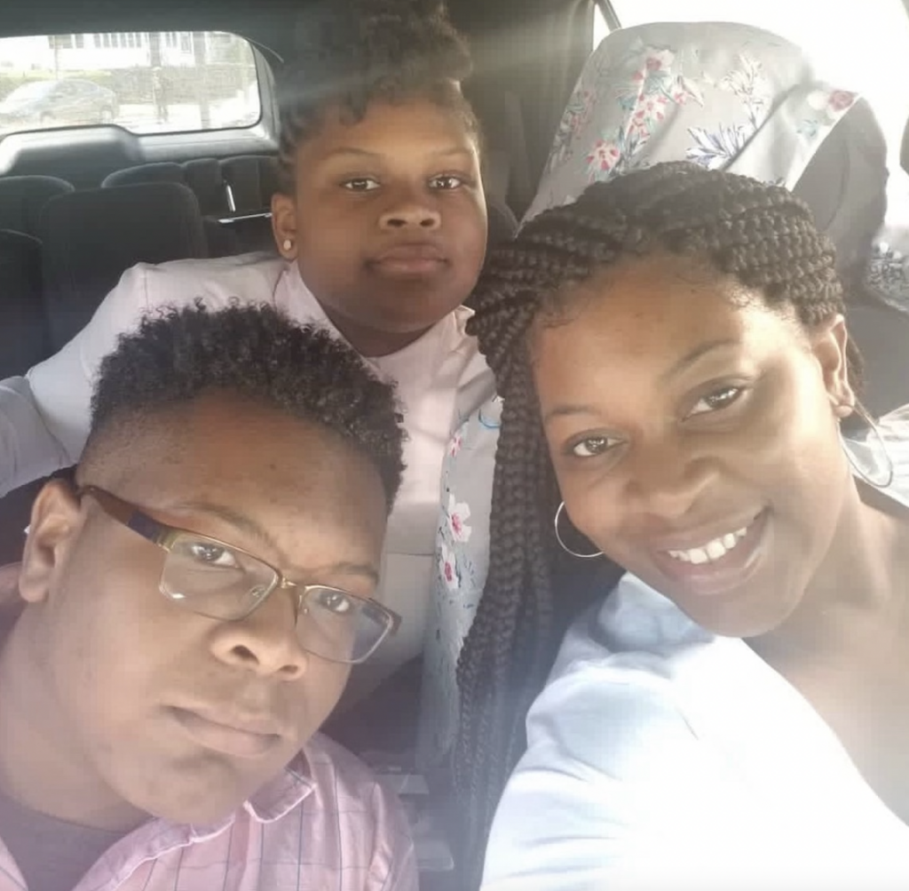 Brooks with two relatives take a selfie in a car
