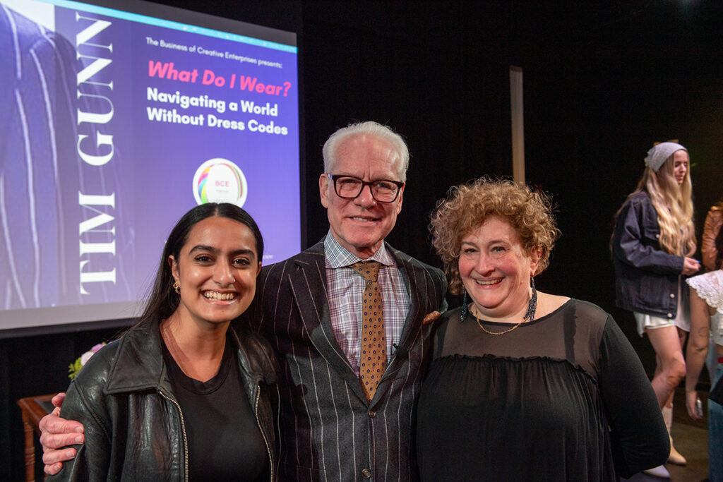 Tim Gunn stands between Diti Kohli and Sharon Topper as they smile for the camera